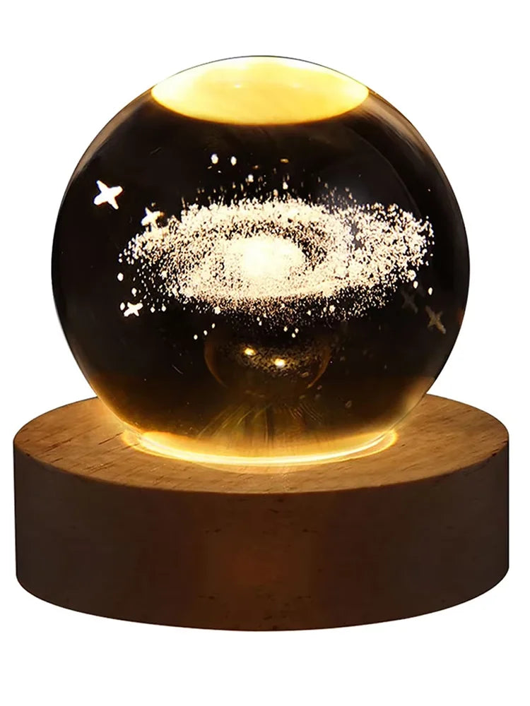 3D crystal ball night light featuring a galaxy design on a wooden base with warm glowing illumination