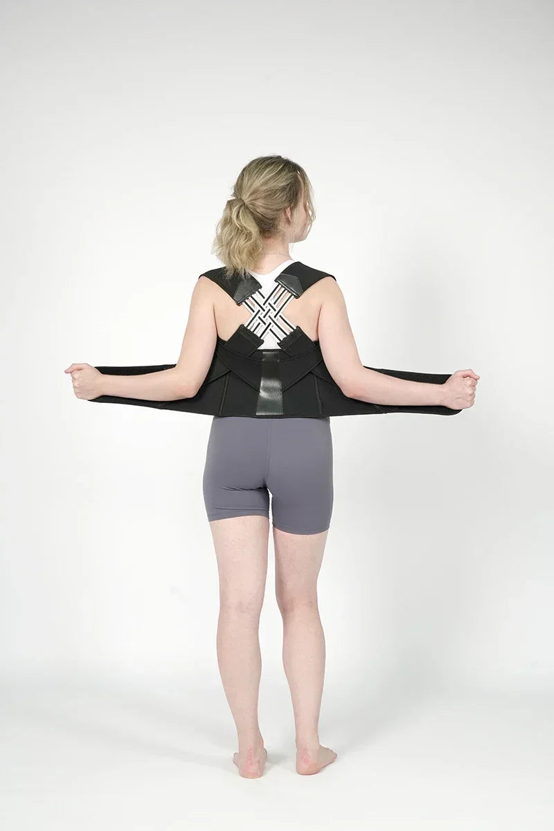 TrevioMart women's back posture brace worn by a woman adjusting straps for support