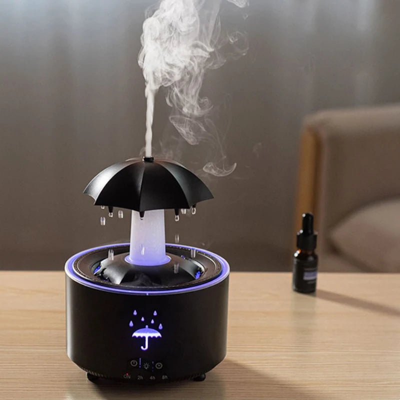 Black raindrop air humidifier with umbrella design emitting mist on wooden table