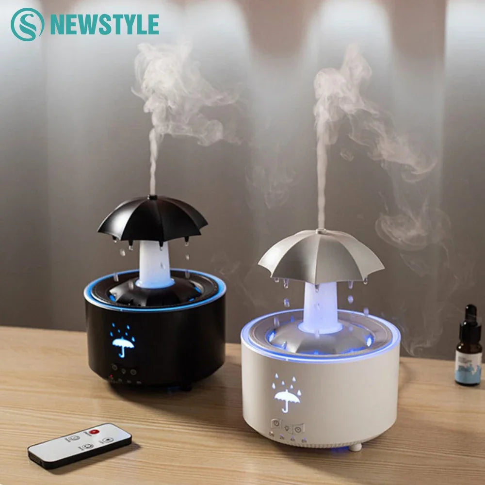Black and white raindrop air humidifier with umbrella design emitting mist on wooden table