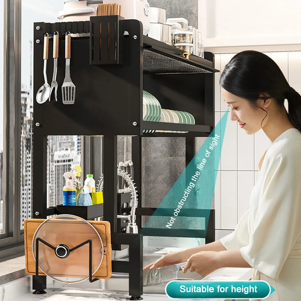 Black over the sink dish rack with storage holding plates, utensils, and kitchen items above a sink